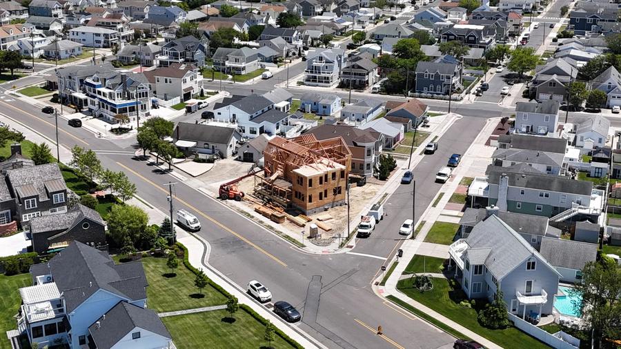 Aerial view of a new home being framed on a corner lot, June 2025