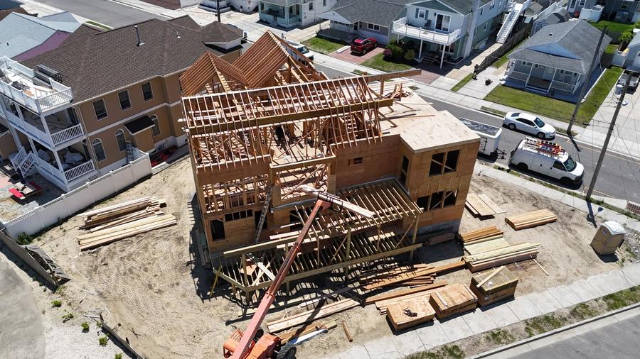 Close aerial view of a new home's wood framing and roof trusses